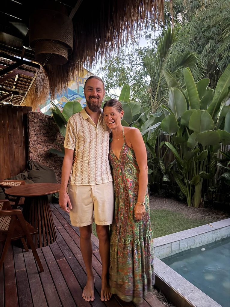 Couple smiling poolside at a tropical villa in Kuta, Lombok