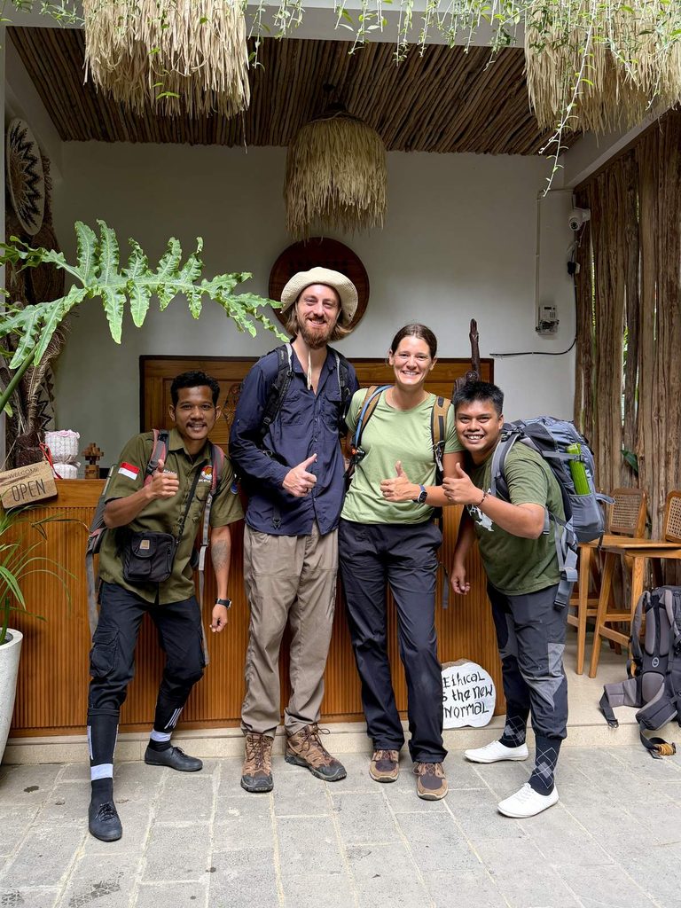 Couple with Sumatra orangutan trekking guides at the ethical tour operator's office