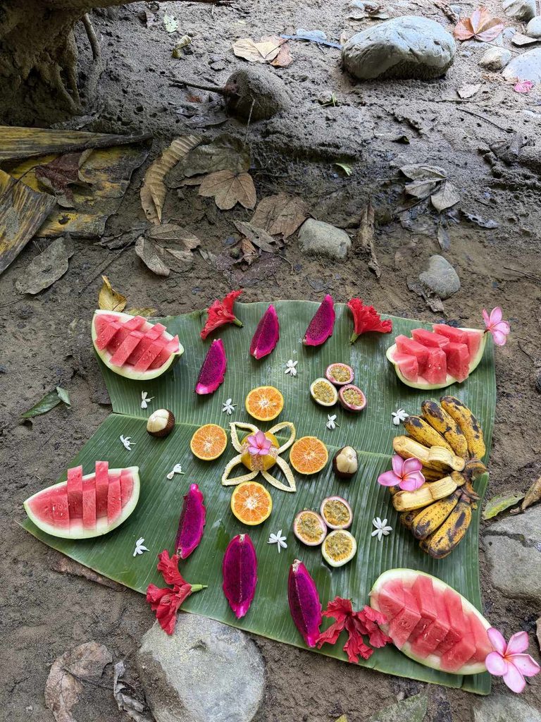 Tropical fruit platter with watermelon, dragon fruit, and bananas on banana leaf in Sumatra jungle