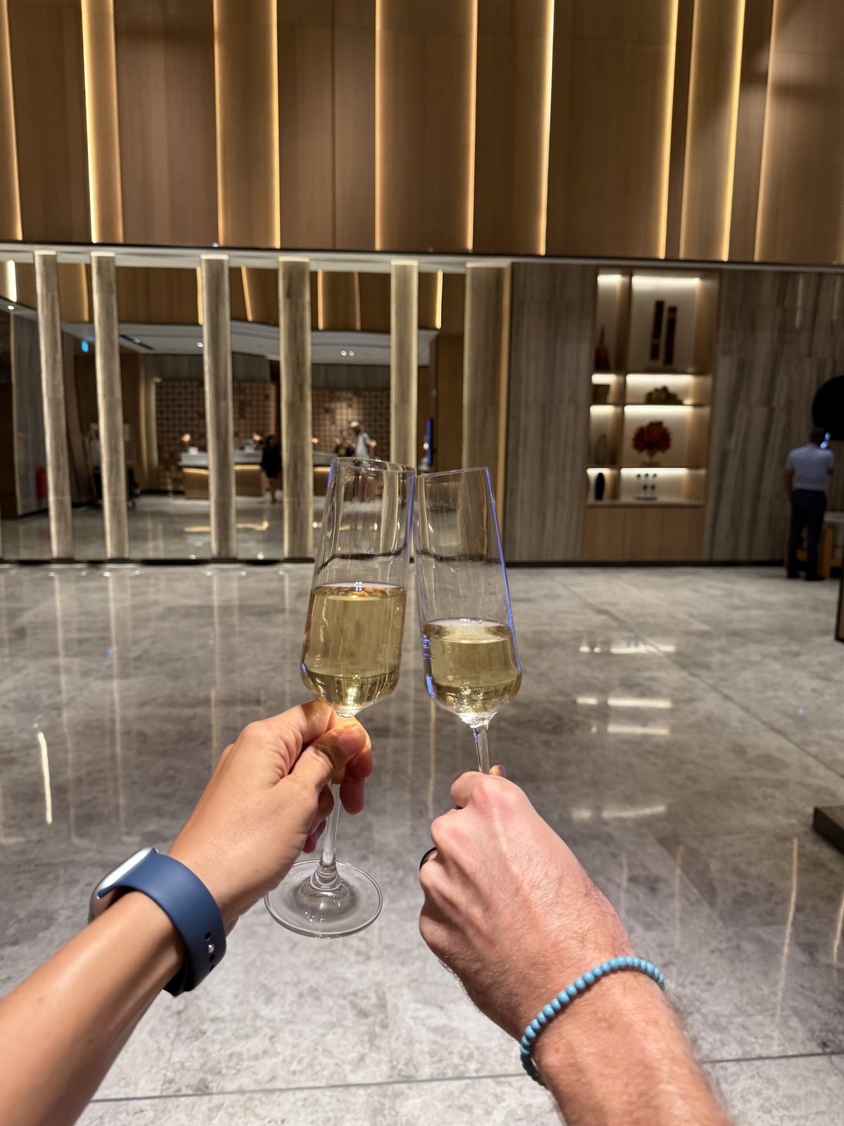 Couple toasting with champagne, celebrating a credit card strategy for couples