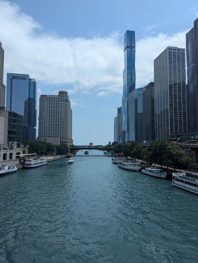 Chicago River lined with architecture tour boats and downtown skyscrapers
