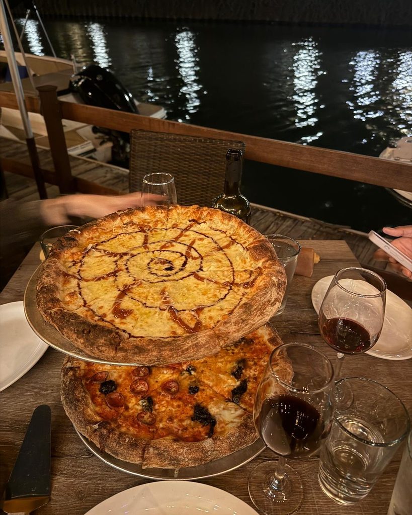 Thin crust pizzas from Roberts Pizza on an outdoor waterfront patio