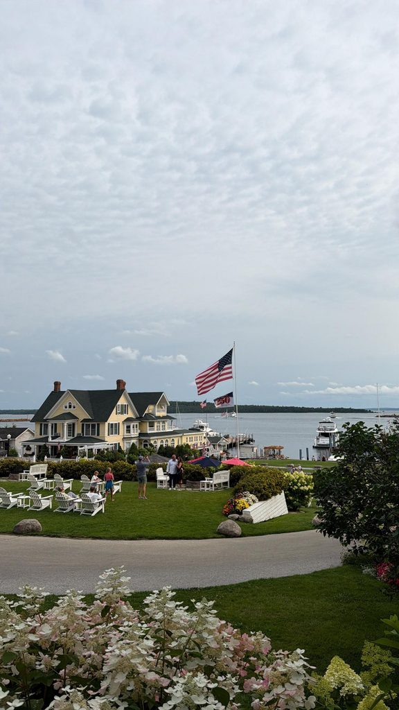 Island House Hotel lawn and porch with the Straits of Mackinac in the background