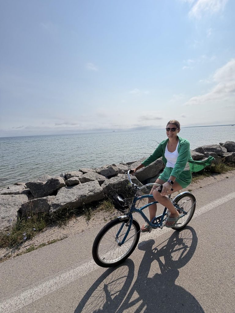 Woman riding a bike along the Mackinac Island shoreline path